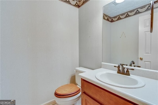 bathroom with vanity and toilet