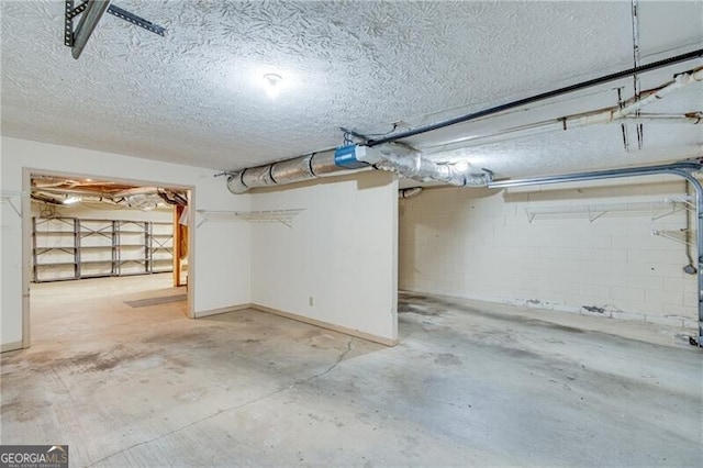 basement featuring a textured ceiling