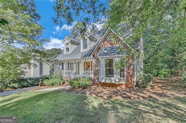 cape cod-style house with a front lawn