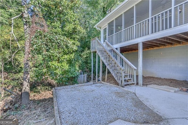 view of patio with a sunroom and stairs
