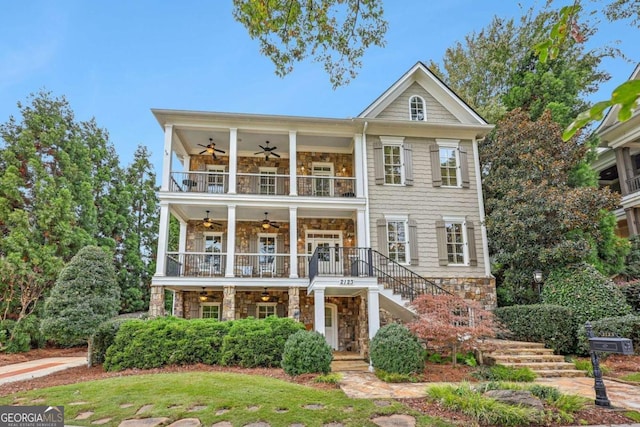 view of front of property featuring a balcony and ceiling fan