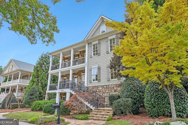 view of front of property featuring covered porch and a balcony