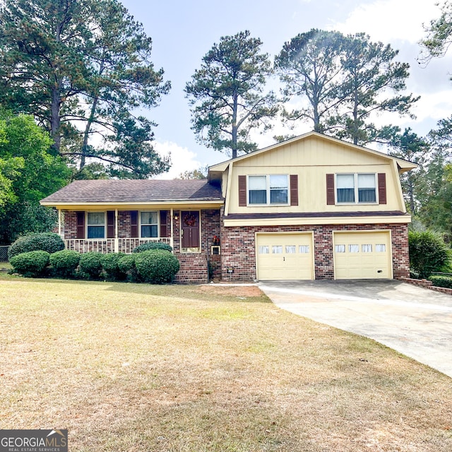 tri-level home with a garage and a front lawn