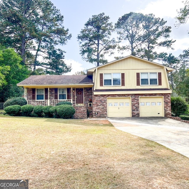 726 Victoria Cir, Dublin, GA 31021 - tri-level home featuring an attached garage, a front lawn, covered porch, and brick siding