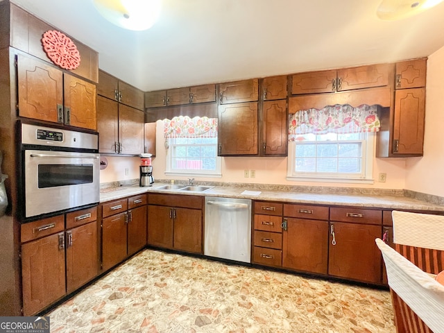 kitchen featuring appliances with stainless steel finishes, a healthy amount of sunlight, and sink