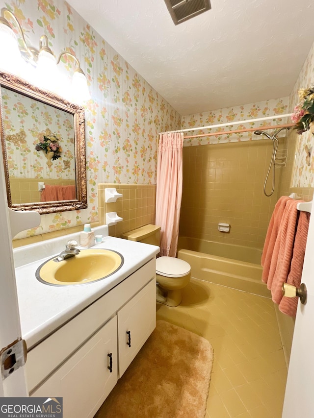 726 Victoria Cir, Dublin, GA 31021 - bathroom with wallpapered walls, shower / tub combo with curtain, vanity, tile patterned flooring, and toilet