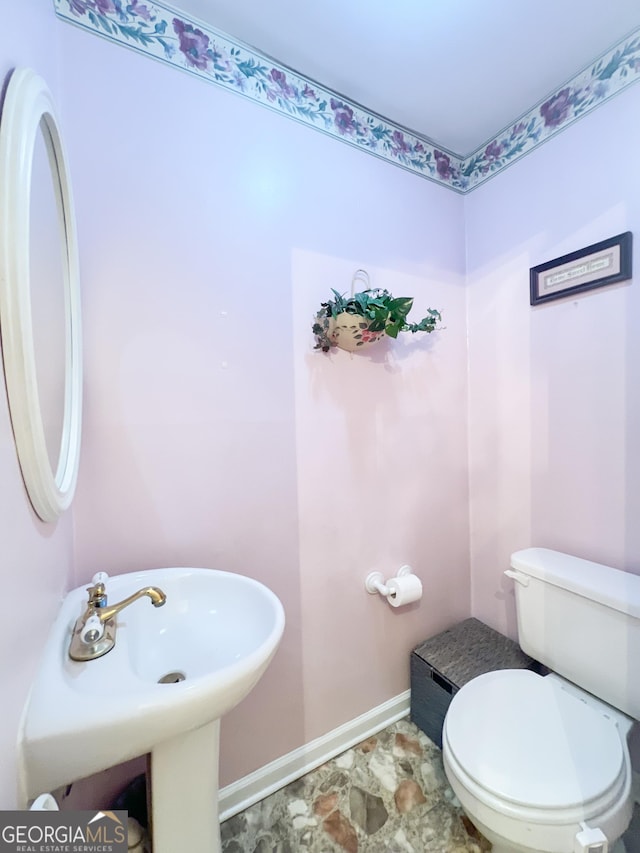 726 Victoria Cir, Dublin, GA 31021 - bathroom with baseboards, toilet, and a sink