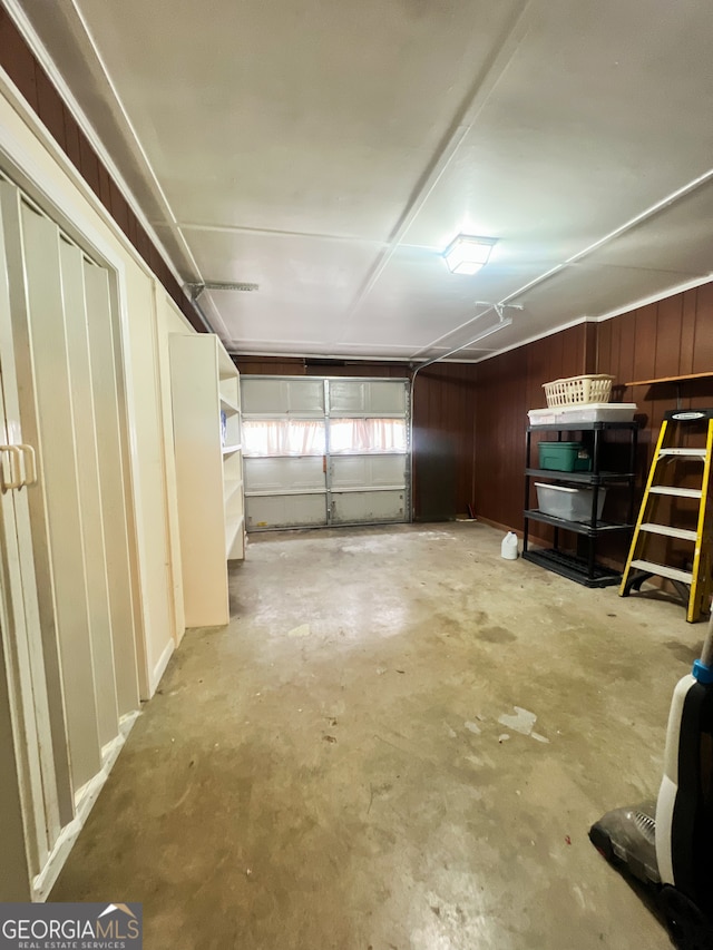 basement featuring wood walls