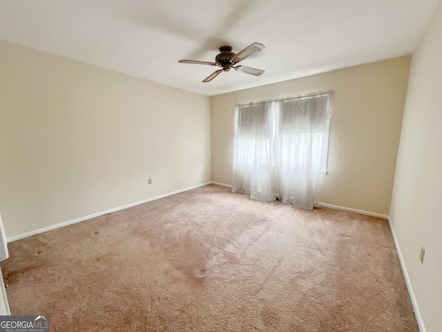 unfurnished room featuring light carpet and ceiling fan