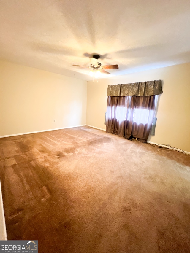 carpeted empty room with ceiling fan