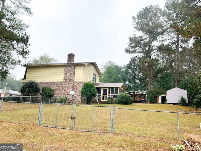 726 Victoria Cir, Dublin, GA 31021 - view of property exterior featuring a chimney, a carport, a gate, and brick siding