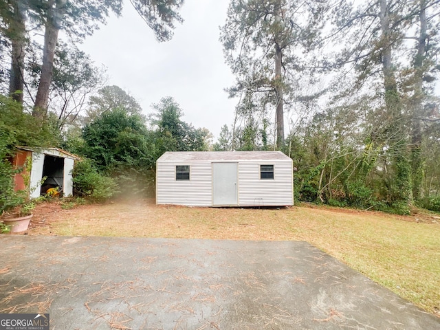 726 Victoria Cir, Dublin, GA 31021 - view of shed with view of wooded area