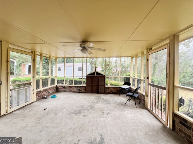 unfurnished sunroom with ceiling fan and a healthy amount of sunlight