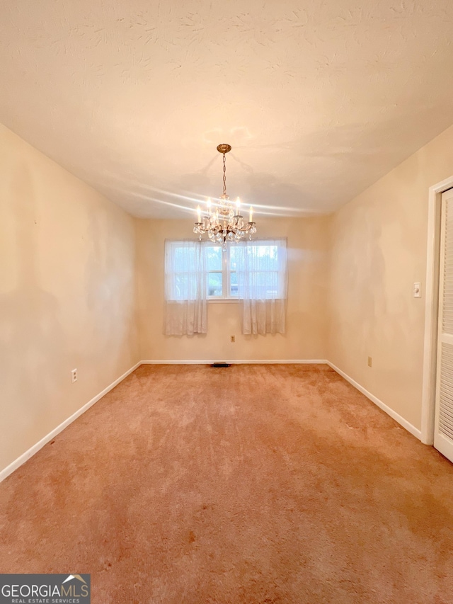 726 Victoria Cir, Dublin, GA 31021 - spare room with carpet flooring, a chandelier, and baseboards