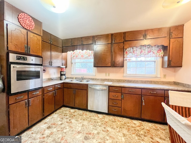 726 Victoria Cir, Dublin, GA 31021 - kitchen featuring stainless steel appliances, a sink, healthy amount of natural light, and light countertops