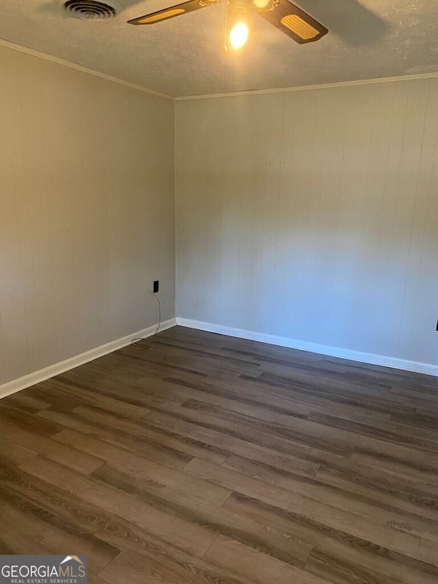 spare room featuring crown molding, dark hardwood / wood-style floors, and ceiling fan