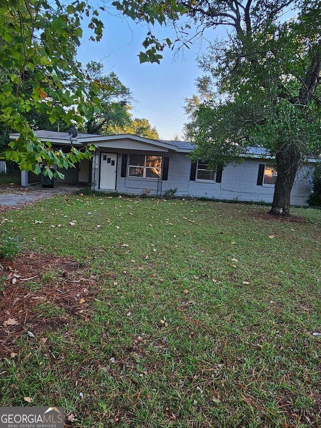 ranch-style home with a front yard