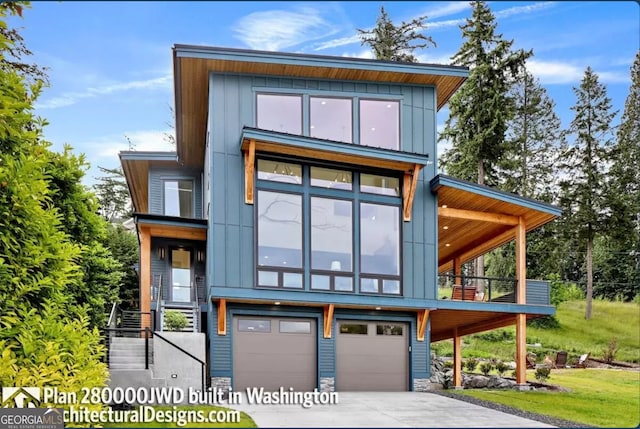 contemporary house with a front yard and a garage