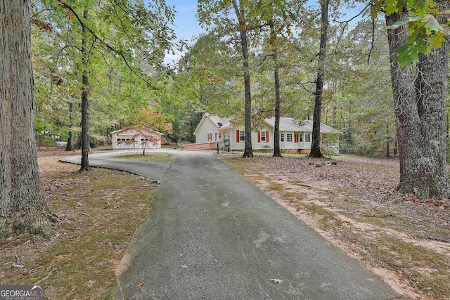 single story home featuring covered porch and a garage