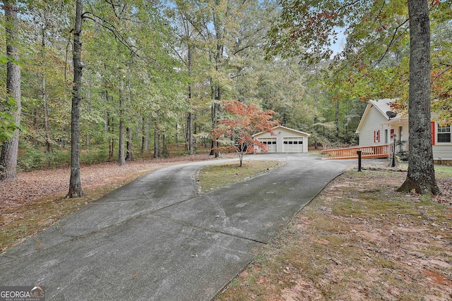 exterior space featuring a garage and an outdoor structure