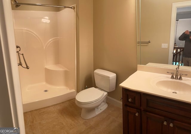 bathroom with vanity, toilet, and walk in shower