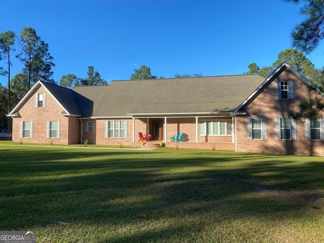 rear view of house with a yard