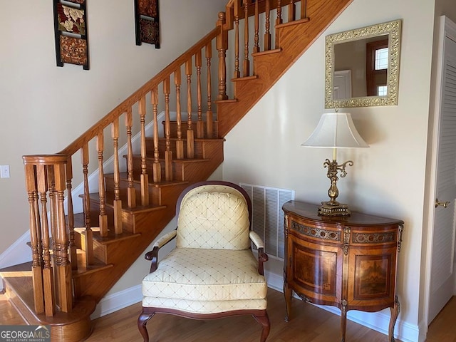 stairs featuring hardwood / wood-style floors