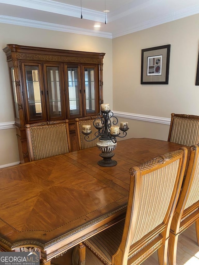 dining space featuring crown molding and wood-type flooring