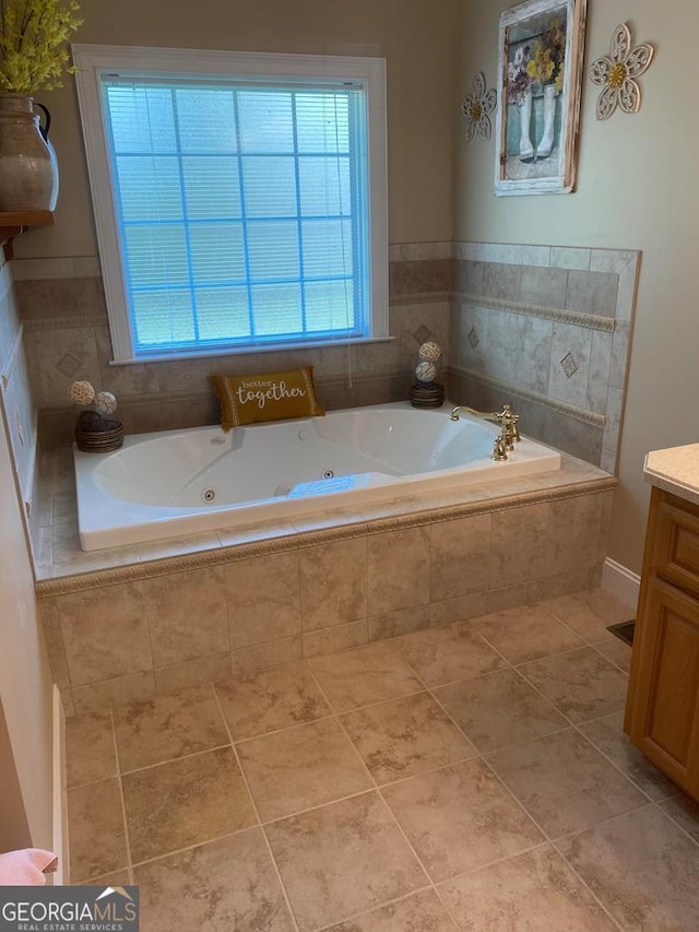 bathroom featuring vanity, tiled tub, and tile patterned floors