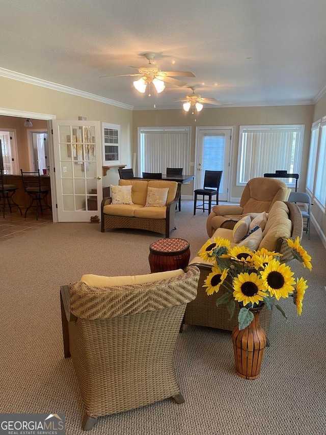 carpeted living room with crown molding and ceiling fan