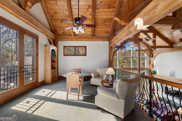 sunroom / solarium featuring wood ceiling, vaulted ceiling with beams, a healthy amount of sunlight, and ceiling fan