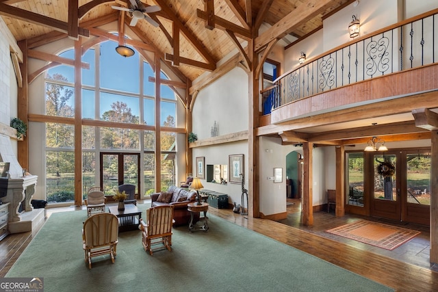 sunroom with vaulted ceiling with beams, wooden ceiling, and a wealth of natural light