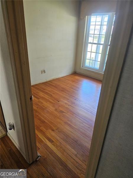 spare room featuring hardwood / wood-style floors