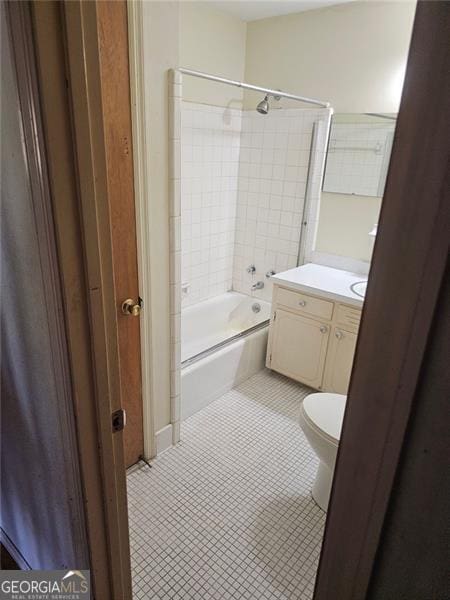 full bathroom featuring vanity, combined bath / shower with glass door, toilet, and tile patterned flooring