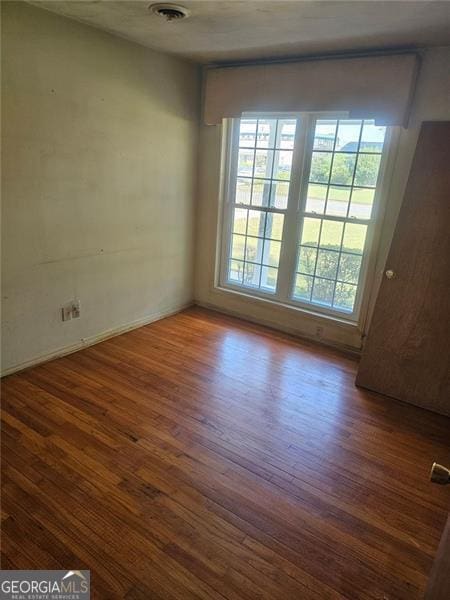 spare room featuring dark hardwood / wood-style floors