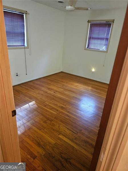 unfurnished room featuring wood-type flooring and ceiling fan