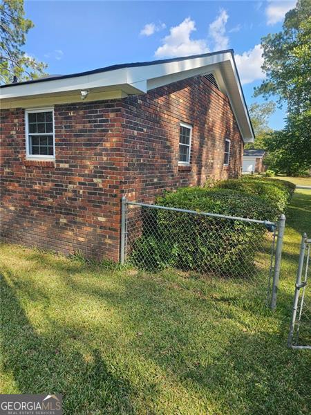 view of property exterior with a yard