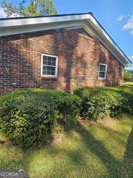 view of home's exterior with a yard