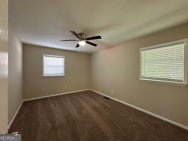 carpeted spare room with ceiling fan