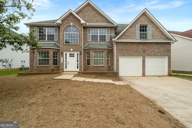 view of front of property featuring central AC and a garage