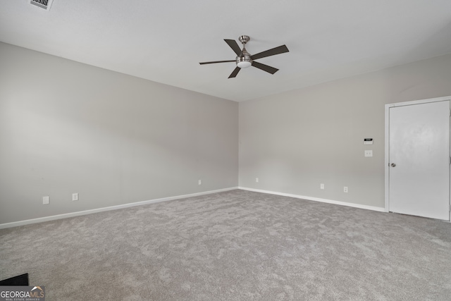 spare room featuring carpet floors and ceiling fan