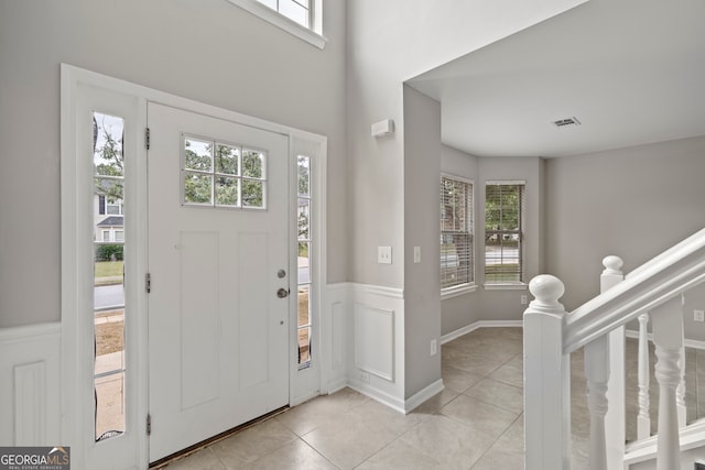 entryway featuring a healthy amount of sunlight and light tile patterned floors