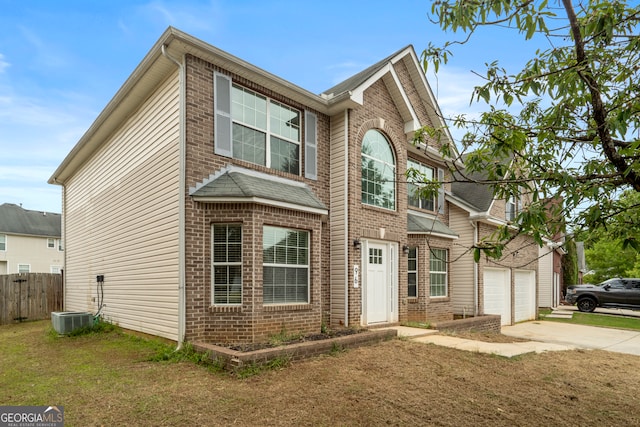 view of front of house with central AC unit and a garage