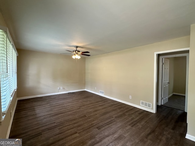 unfurnished room with ceiling fan and dark hardwood / wood-style floors