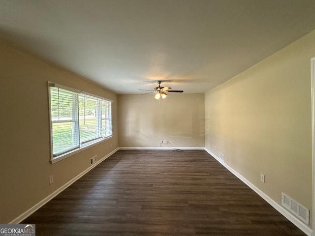 empty room with ceiling fan and dark hardwood / wood-style floors