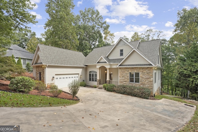 124 S Shore Dr, Fair Play, SC 29643 - view of front of property with stone siding, a porch, roof with shingles, concrete driveway, and an attached garage