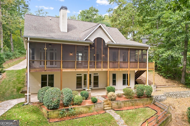 rear view of house featuring a patio and a sunroom