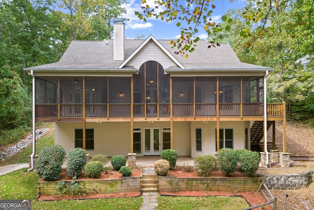 back of house with french doors, a sunroom, and a patio area