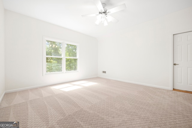 spare room featuring light carpet and ceiling fan