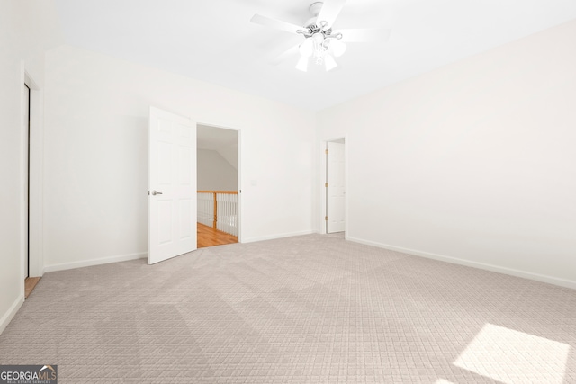 unfurnished bedroom with light colored carpet and ceiling fan